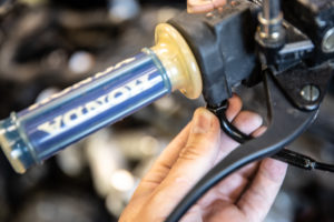 This photo shows removing the cable from the throttle assembly.