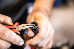 This photo shows pulling the cable with needle nose pliers.