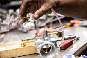 This shows removing the needle seat, baffle plate and other careburetor parts.